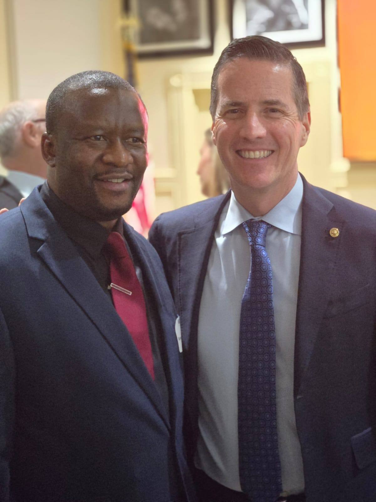 Akotarh Akoson at a political reception with a U.S. official